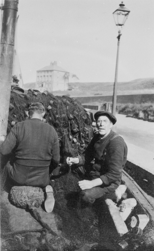 William Dougal, Skipper of 'Amaranth', BK81, at Eyemouth harbour, 1930. The man with his back to the camera is David Lough. In the background, gunscreen house. Original - M. Fairnie via C.Carruthers.