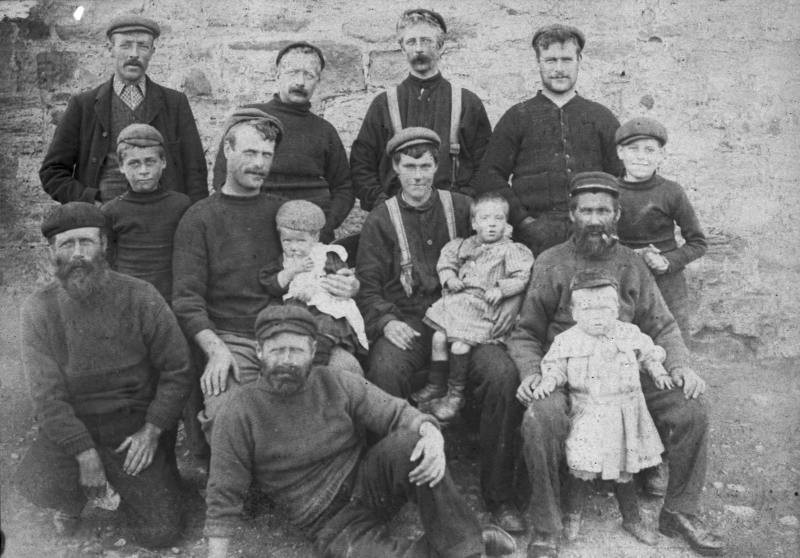 Group portrait of ten fishermen and their families, Cove, c.1900