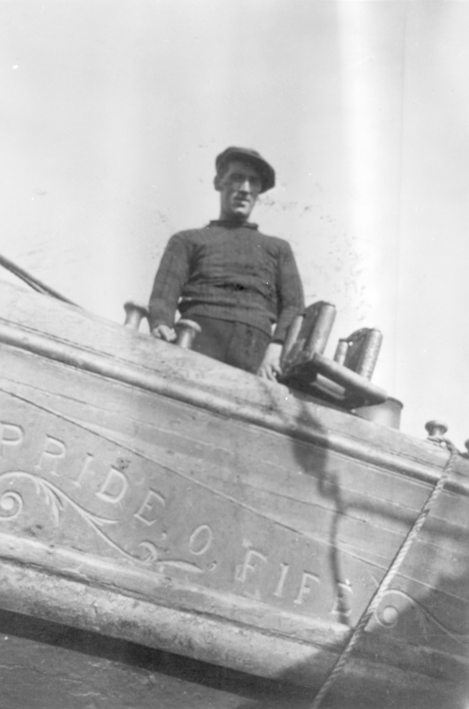 Crew member on board 'Pride O Fife', KY218. He is standing beside the 'messenger' rollers.