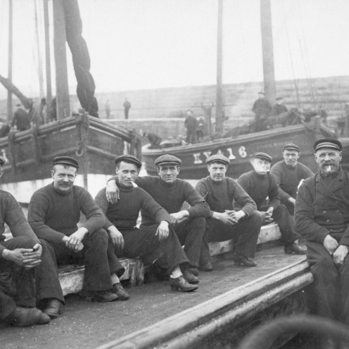 Crew of 'Guide Me', KY301. Taken in Port Dover, Canada, 1906. 'Jessie Hughes', KY416, can be seen in the background. L-R: William Davidson (known in Port Dover as Scotty Bill), Robert Davidson, John Wood, Richard Davidson, Alex Brown, Robert Muir, Alex Muir, Alex Watson, and Captain Robert Davidson