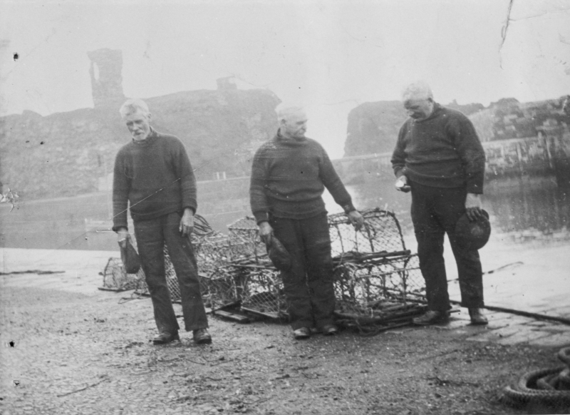 Three fisherman taking part in a two minute silence on Armistice Day, Victoria harbour, Dunbar. L-R: Unknown, unknown, John 'Gallagher' Johnstone. Johnstone was the Skipper of then 3.15 ton 'Isa', LH202. Alex Johnston was the owner. Original - C. Carruthers.