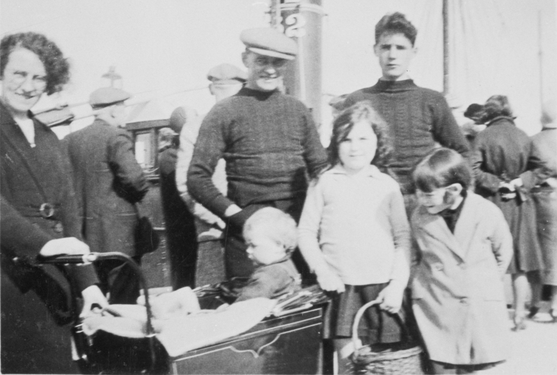 Group of people on Anstruther pier, 1932. Back row, L-R: Phemie Corstorphine, David Corstorphine, David Corstorphine, John Ballingall, Front row, L-R; Sonny Corstorphine (in pram), Unknown Ballingall, Jessie Corstorphine.
