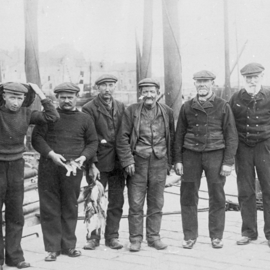 Six men, Pittenweem. Two of the men are holding flat fish. L-R: James Hughes, Thomas Hughes, Thomas Spense, James Dewar, William Horssburgh, and John Doig.