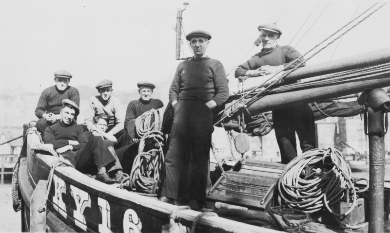 Crew onboard 'Good Hope', KY165, c. 1938. Seated men, top row, L-R: David Corstorphine, Patterson Wallace, Unknown. Seated men, bottom row, L-R: Bobby Duncan, Unknown. Standing men, L-R: George Gourlay, Billy Smith. Original image from E. Doig, Cellardyk