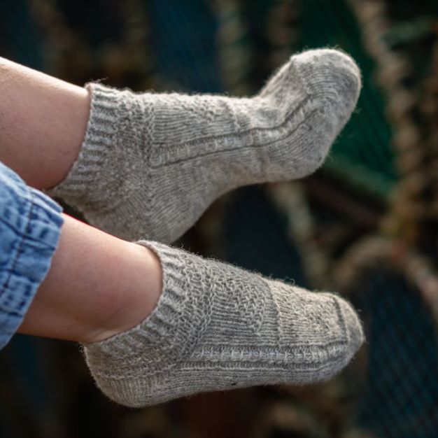 Two feet wearing Rubha Liath Eriskay socklets.